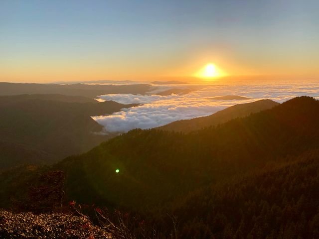 Sunset over a sea of clouds filling the valleys below Mount Le Conte