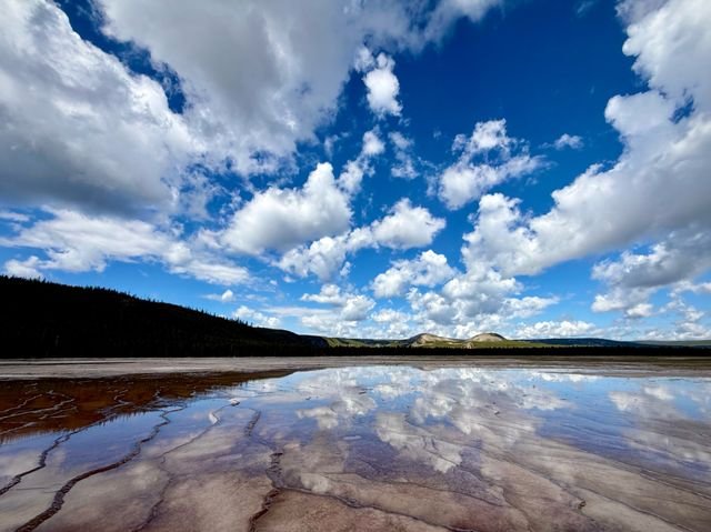 Clouds reflected in a thermal terrace, Yellowstone